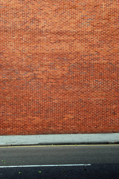 istock Urban background UK - Red brick wall with sidewalk 157473032