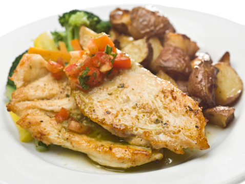roasted chicken breast served with roasted potatoes and freshly steamed vegetables on white background (this picture has been taken with a Hasselblad H3D II 31 megapixels camera)