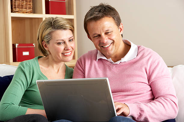 Middle Aged Couple Using Laptop stock photo