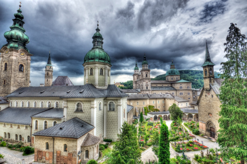Unique perspective of Salzburg's famous old town showing the Salzburg Cathedral, Abbey of St. Peter, Cemetery and St. Francis Church, which can be seen in the background. 