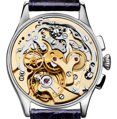 Watch collector is adjusting the mechanical watch in his workshop