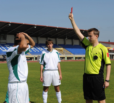 Referee showing yellow card