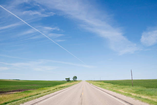 istock deserted road with vapor trail above 157474967