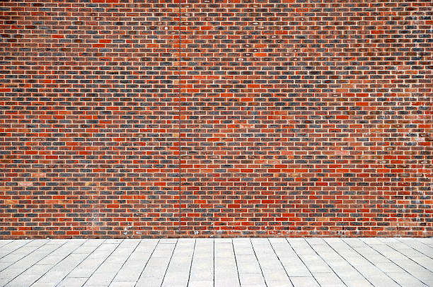 istock Urban background UK - Red brick wall with sidewalk 157475002