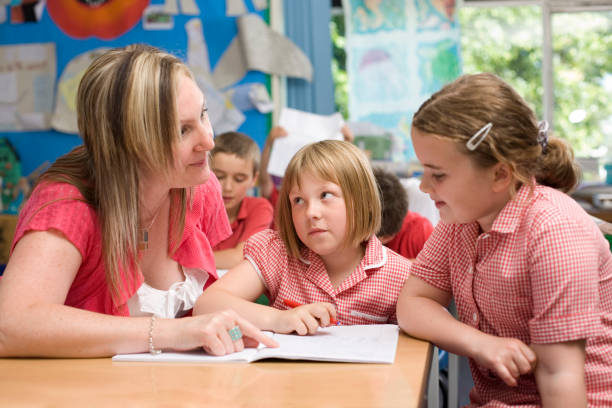 istock Primary school teacher with children in class 157475212