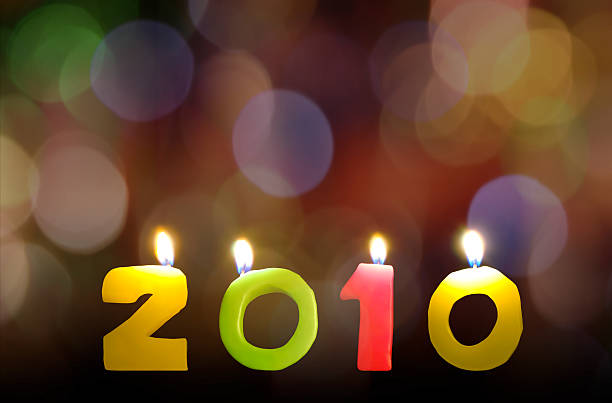 istock New year 2010 candles on rainbow bokeh background 157475237