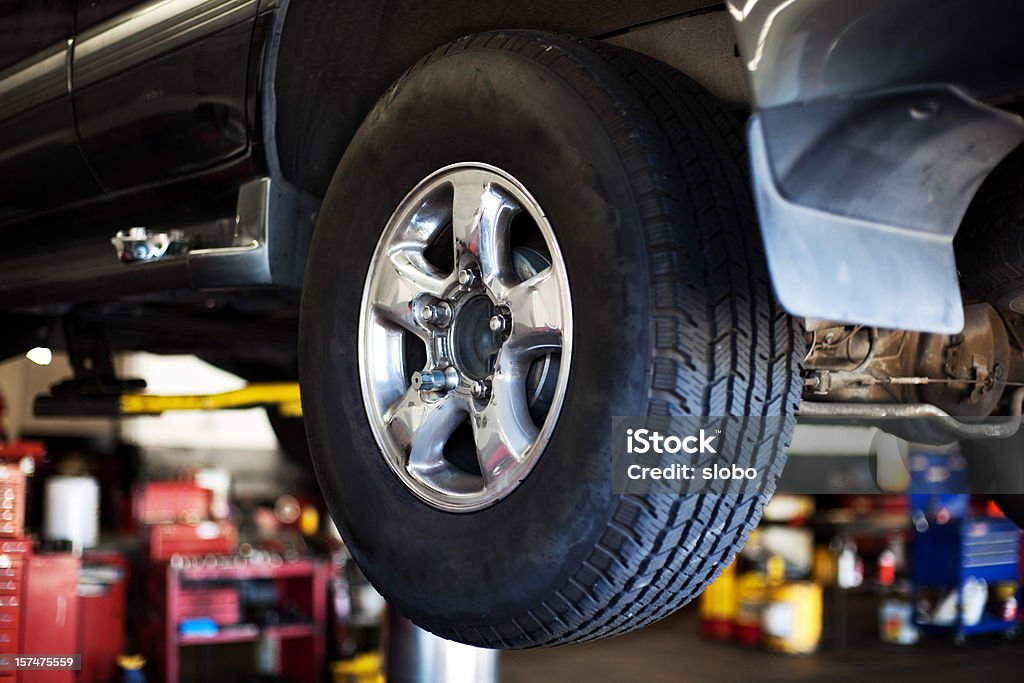 Car in auto mechanic shop Auto mechanic shop. Shallow DOF At The Edge Of Stock Photo