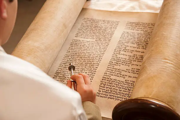 A young man reads the Torah as part of his Bar Mitzvah.