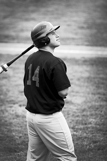 istock black & white teenage baseball player 157476173