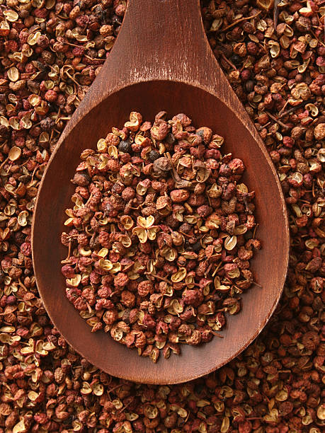 Szechuan peppercorns Top view of wooden spoon full of Szechuan peppercorns sichuan province stock pictures, royalty-free photos & images