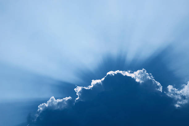 cloudscape with sun beams stock photo