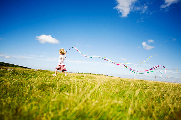 istock Girl running in a meadow 157476309