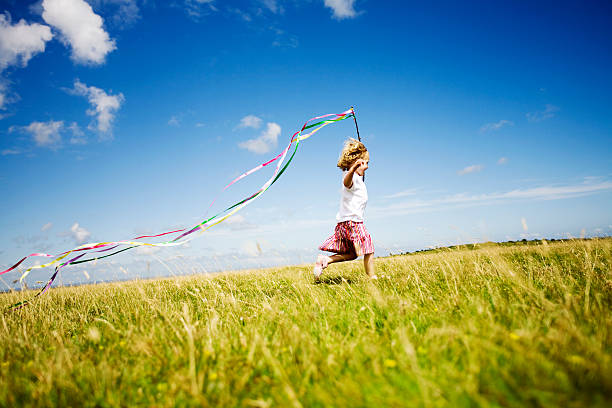 istock Girl running with streamers 157476310