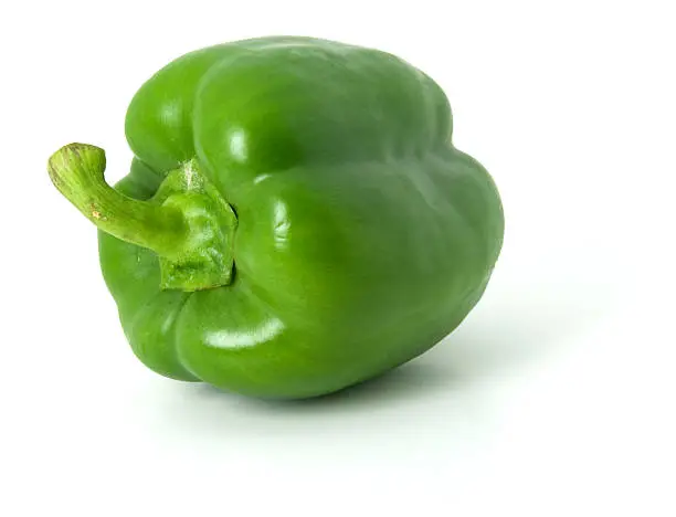 Photo of One green bell pepper isolated on a plain white background