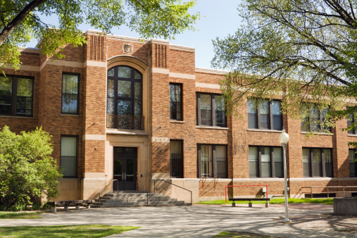 A building exterior on a school campus that may be a university lecture hall, college dorm, schoolhouse, or other higher education architecture.