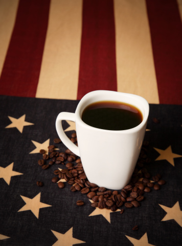 American flag and cup of coffee - conceptualizing American Coffee