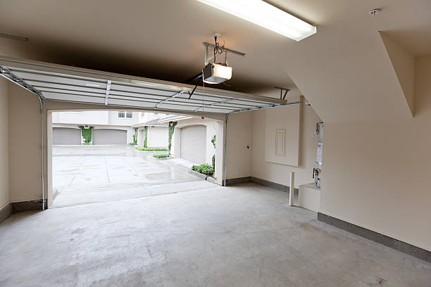 Empty Garage Looking Out Empty garage with open door, looking from inside garage door installation stock pictures, royalty-free photos & images