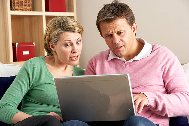 Middle Aged Couple Using Laptop stock photo