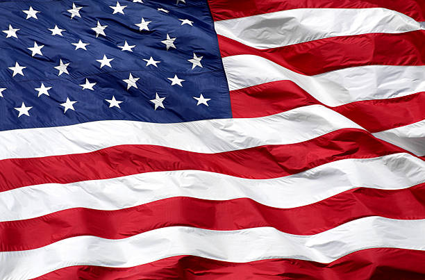 American Flag Background A close-up of an American flag which is flying in the wind. flag backdrop stock pictures, royalty-free photos & images