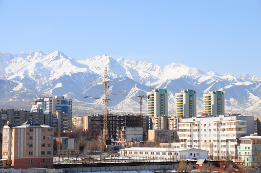 Panoramic view of Almaty city with a beautiful mountain range in the background.