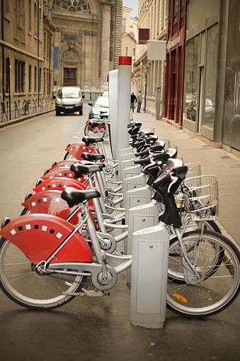 Close-up of several scooters for rent by the rental and sharing system on the street in the city. Infrastructure and improvement of urban life.