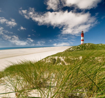 A panorama view of sand dunes on the Jutland coast of Denmark with the Lyngvid Fyr lighthouse