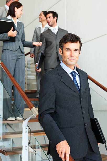 istock Businessman with colleagues in background 157477586