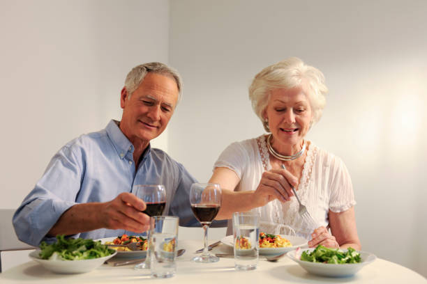 istock seniors eating evening meal 157477747