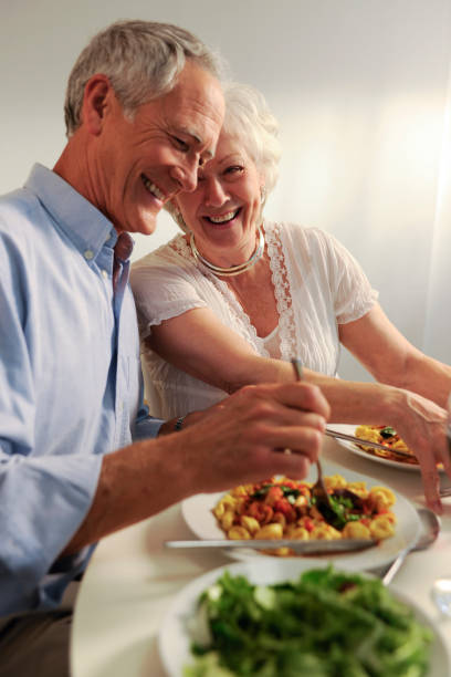 istock seniors eating evening meal 157477808