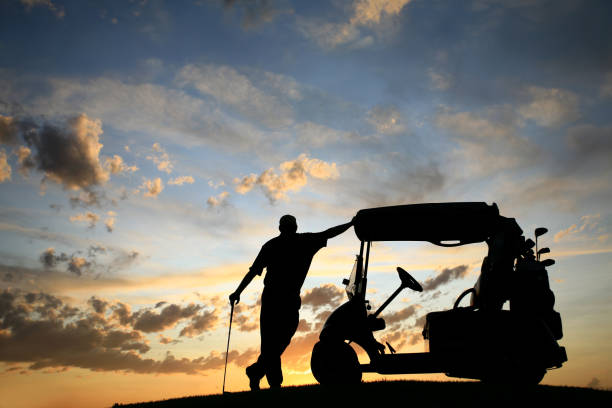 istock Golfer resting at golf cart at sunset 157478157