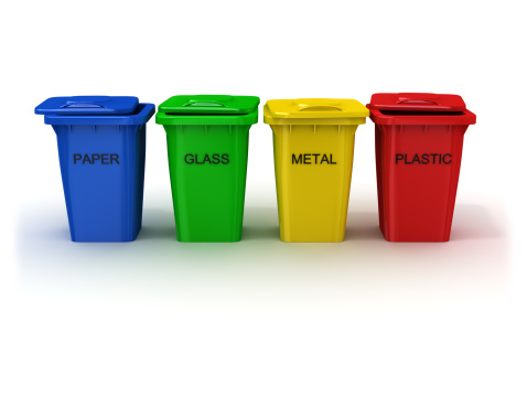 Multicolored toy plastic bins for different waste types, separate garbage collection concept