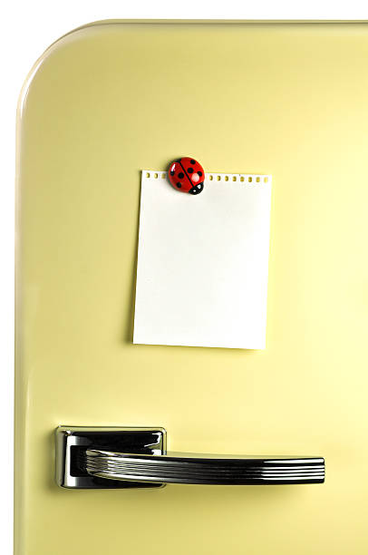 Blank notebook paper on fridge with magnet stock photo