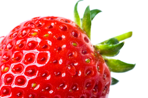 Fresh red ripe strawberry with green leaves isolated on white background with water drops. Studio shot.