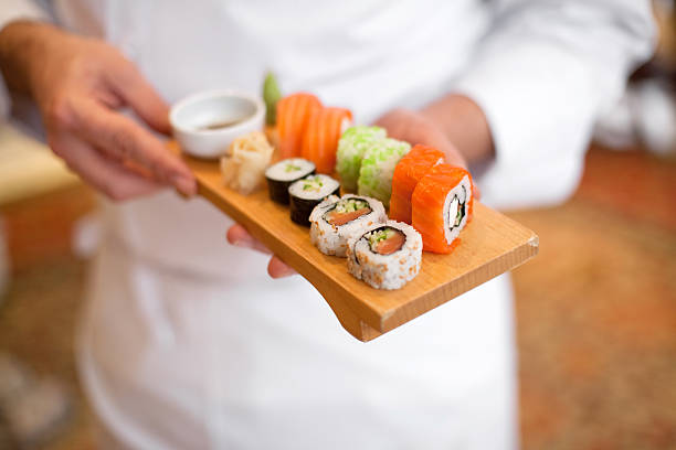 Sushi sushi chef holding sushi plate. japanese food stock pictures, royalty-free photos & images