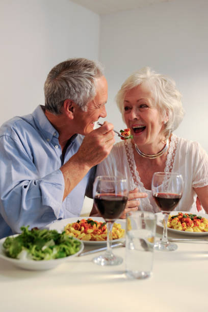 istock seniors eating evening meal 157478554