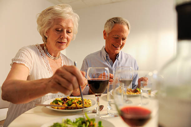 istock seniors eating evening meal 157478599