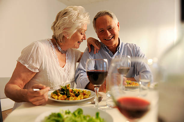 istock seniors eating evening meal 157478601