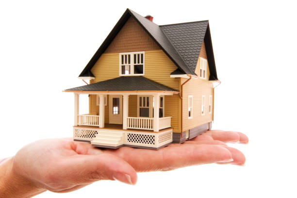 istock Miniture house model human hand displaying american dream isolated 157478619