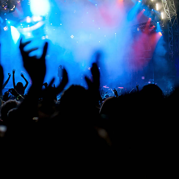 istock raised hands on a music concert 157478718