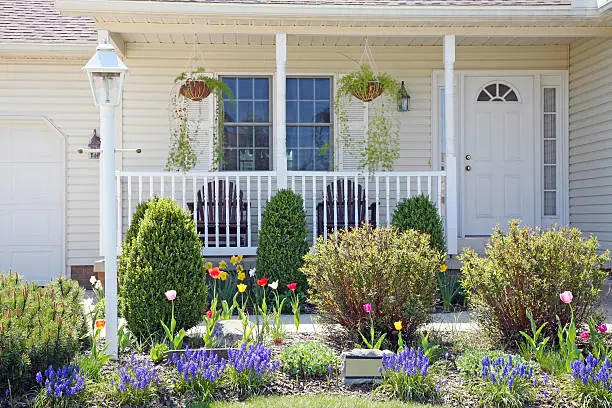 Photo of Pretty Home Facade With Spring Landscape