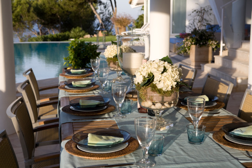 Table setting beside in the grounds of a luxury villa.