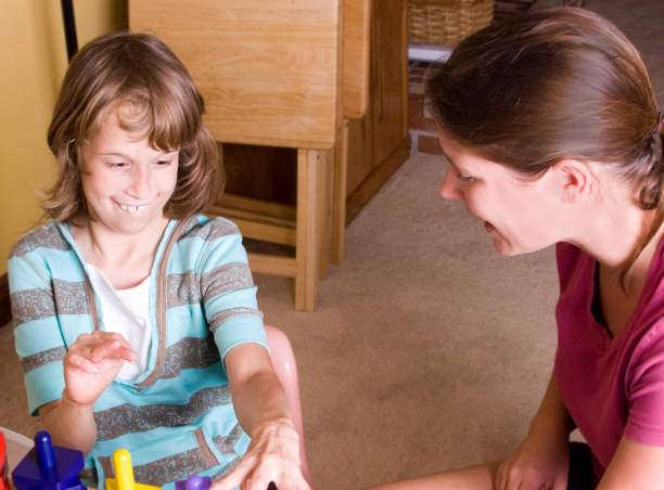 istock Therapist working with cute autistic girl 157479137