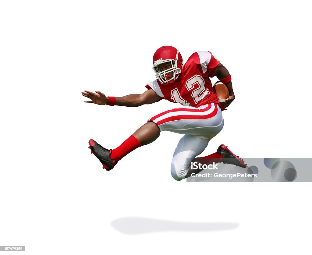 Football Player Running and Jumping with Clipping Path Football player running and jumping to avoid tackle. Great action. Some motion blur. Clipping path included in file. American Football Player Stock Photo