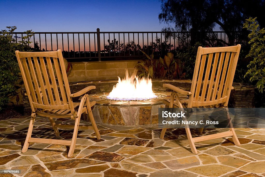 Fire-Pit, Back Yard Outdoor, Seating, Fire, Sunset, View, Luxury A beautiful firepit in the back yard makes for relaxing luxury. Comfortable seating areas for good conversation. Fire Pit Stock Photo