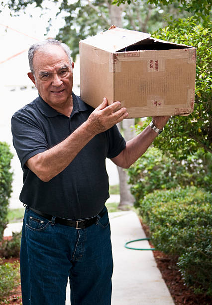 istock Busy Senior Carrying a Heavy Box 157479720
