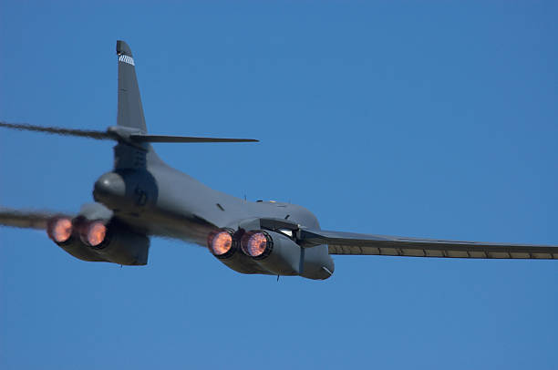 B1 Lancer Bomber military airplane. Rear view of a military airplane. Showing afterburner and slightly blurry effect due to hot exhaust gasses. b1 bomber stock pictures, royalty-free photos & images