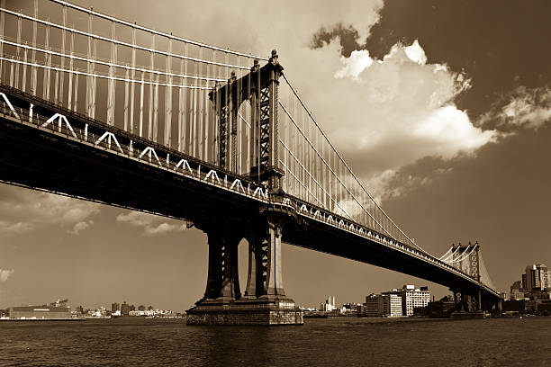 Manhattan Bridge in Sepia The Manhattan Bridge, like the Brooklyn Bridge, links Manhattan and Brooklyn, in New York City. Finished in sepia for a more classic look. brooklyn bridge photos stock pictures, royalty-free photos & images