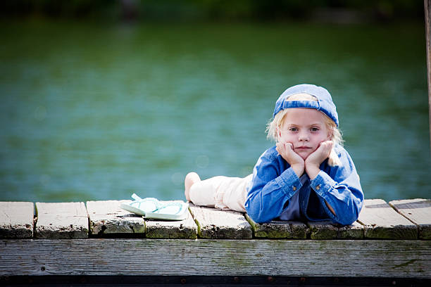 Girl Standing On Stone Bench At Park