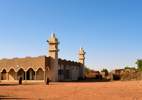 Liboré,  Kollo Department, Tillabéri Region, Niger: the Main Mosque (Sunni) with its twin minarets - red earth pavement of the central square of the small town - countryside Mosque.