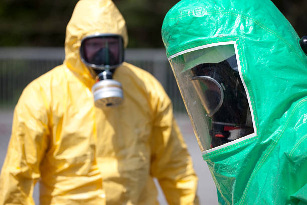 zwei männer in schützende kleidung - radiation protection suit toxic waste protective suit cleaning stock-fotos und bilder